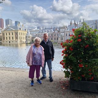 A small group with Dennis in front of a historic Amsterdam house